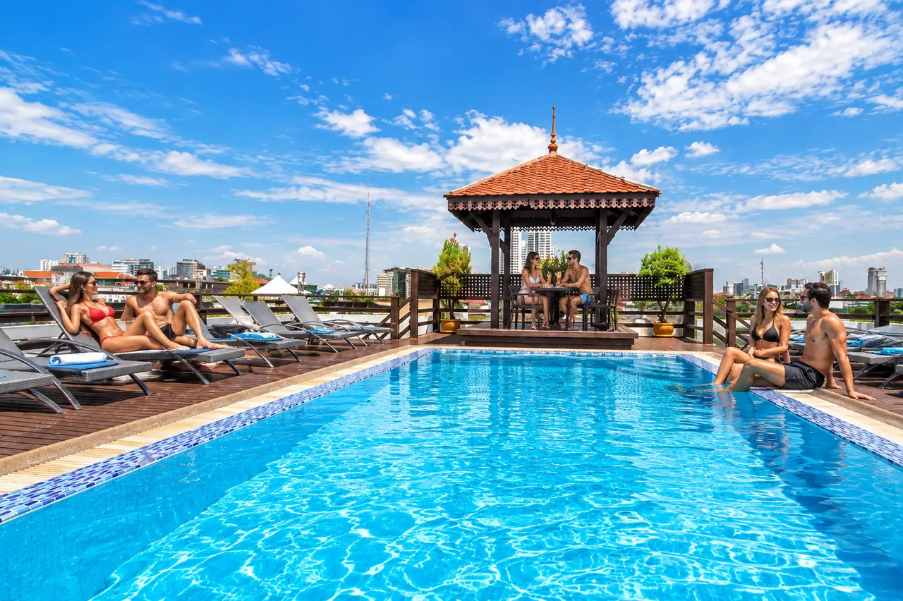 Guests enjoying the rooftop swimming pool at Khaosan Palace Hotel